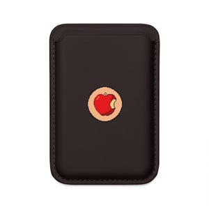 May include: A dark brown phone case with a stitched border. A pixelated red apple with a bite taken out of it is centered on the case, set within a tan circle.