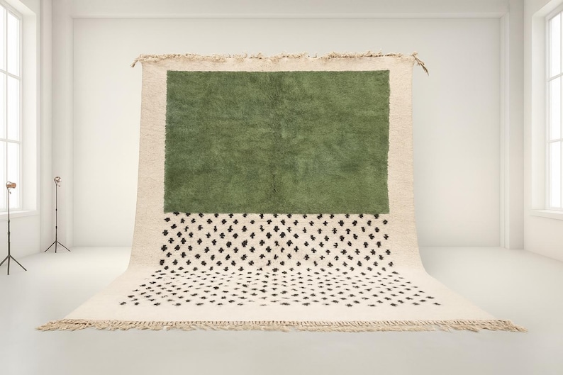 a large, square rug with a green background and a white and black patterned area on the bottom.
