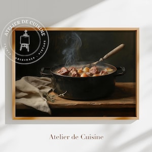 May include: A framed print of a vintage kitchen scene. A black cast iron pot filled with stew sits on a wooden surface. Steam rises from the stew, and a wooden spoon rests inside. The print is labeled "Atelier de Cuisine."