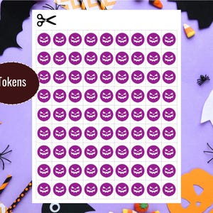 May include: A sheet of purple Halloween tokens featuring jack-o'-lantern faces, ready to be cut out. The word "Tokens" is on a brown circle. Halloween decorations, including a bat, spiders, and candy corn, surround the sheet.