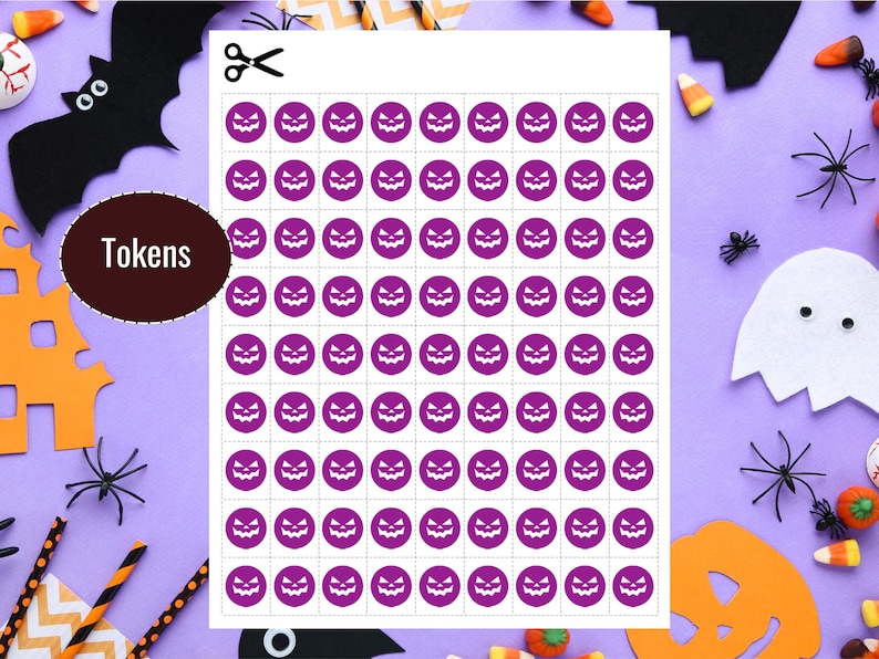 May include: A sheet of purple Halloween tokens featuring jack-o'-lantern faces, ready to be cut out. The word "Tokens" is on a brown circle. Halloween decorations, including a bat, spiders, and candy corn, surround the sheet.