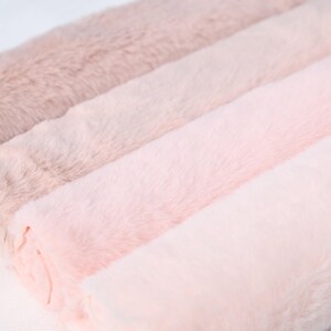 Faux rabbit fur with short plush fibers in pink tones, measuring 25 × 50 cm. Ideal for DIY sewing, fursuit features, costume trims, or handmade plush animals. This soft and flexible synthetic material is cruelty-free and beginner friendly, making it perfect for cozy, close-contact projects.