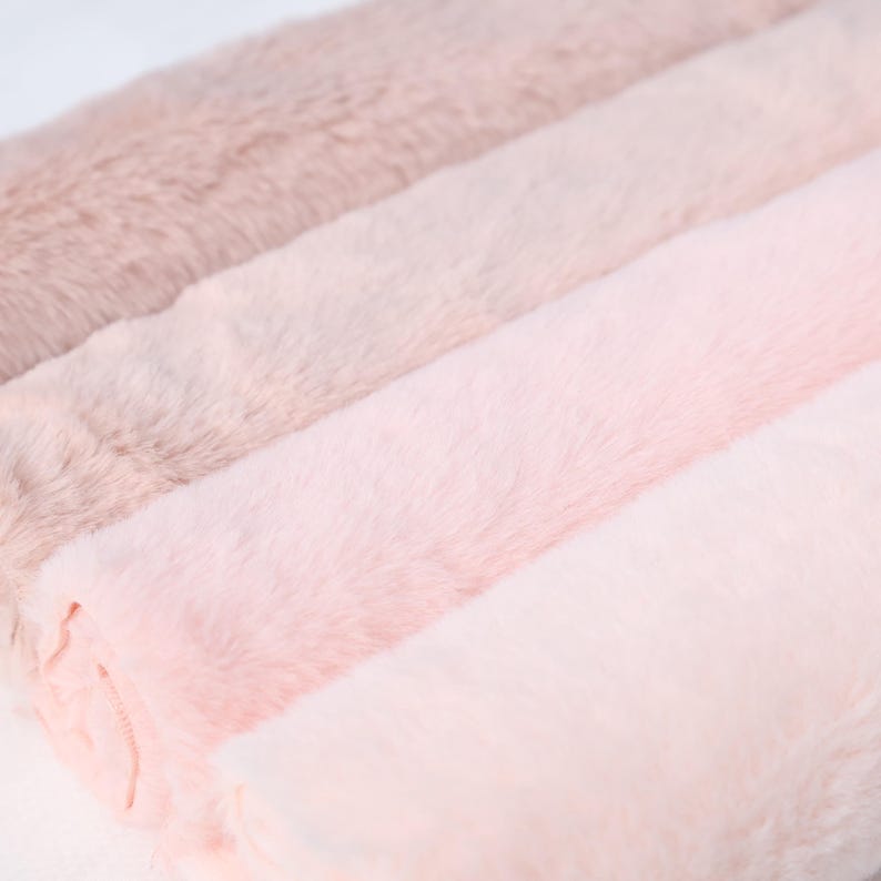 Faux rabbit fur with short plush fibers in pink tones, measuring 25 × 50 cm. Ideal for DIY sewing, fursuit features, costume trims, or handmade plush animals. This soft and flexible synthetic material is cruelty-free and beginner friendly, making it perfect for cozy, close-contact projects.