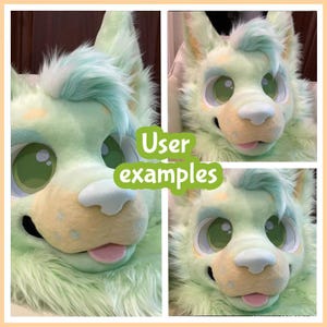 May include: A plush animal head mask featuring mint green faux fur, large expressive green eyes with white highlights, a soft white nose, and a small pink tongue protruding from the mouth. The head has pointed ears and a tuft of light blue hair.
