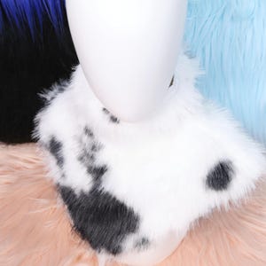 Unique cow pattern faux fur collar made for fursuit creators and animal cosplay lovers. Its spotted pattern and thick texture replicate real cow hide but in a fully synthetic, cruelty-free form. The soft lining inside keeps the wearer warm while ensuring comfort during conventions or long performancesBlack and white faux fur neck accessory with realistic cow print texture.