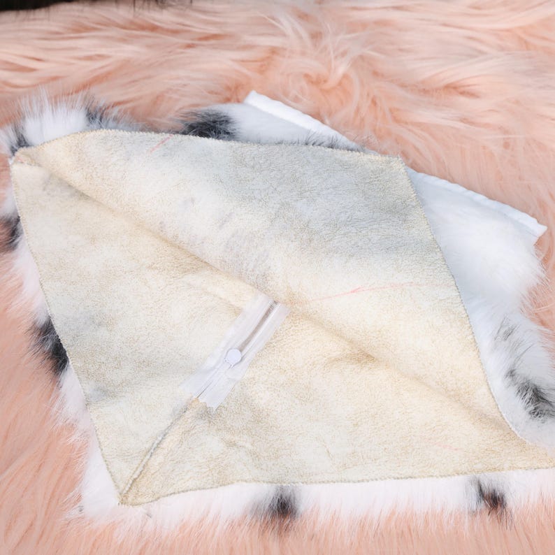 Black and white cow-patterned fursuit neck fur crafted from high-quality faux fur material. Designed with smooth inner lining for comfort and warmth, it mimics natural animal patterns while remaining cruelty-free. Perfect for cosplay enthusiasts, furry community members, or costume designers seeking unique farm-inspired accessories for their characters.