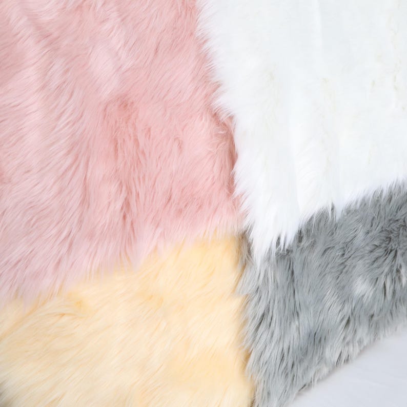 Faux fur fabric with thick long pile in a lightweight construction, measuring 2.36 inches tall. Great for making fluffy costume details like fursuit paws, plush animal tails, or fantasy ears. The soft synthetic material is cruelty-free and easy to work with, making it an ideal choice for cosplay, plush art, and costume making.