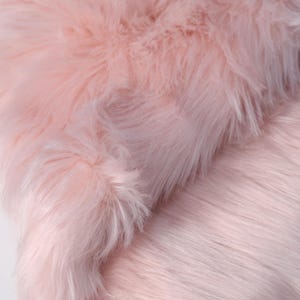 High-density faux fox fur fabric with 2.36 inch pile and soft fluffy finish. Designed for fursuit paws, tails, ears, and plush crafting. The 45 × 85 cm size offers enough fabric for multiple small parts or detailed character builds. Made from cruelty-free synthetic fibers, it provides premium fur texture and durability in a lightweight format.