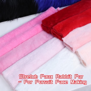 May include: A selection of colorful faux rabbit fur fabric in shades of pink and red. The image includes the text "Stretch Faux Rabbit Fur - For Fursuit Face Making". The fabric is soft and fluffy, ideal for crafting.