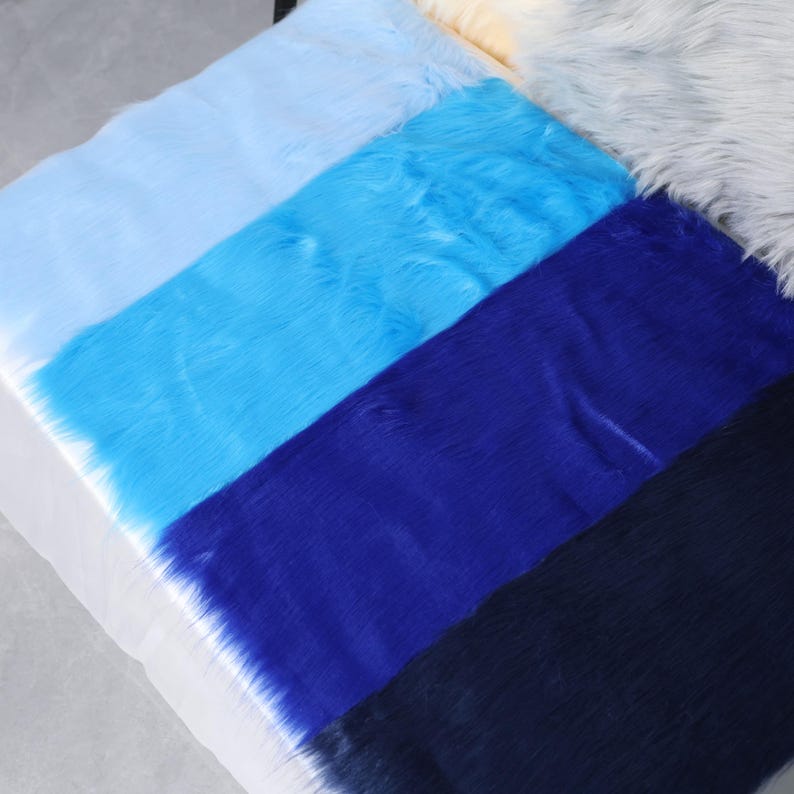 Faux fox fur fabric in brilliant blue tones with a realistic 5 cm pile, offering soft texture and lifelike appearance. Made from high-quality synthetic fibers, this piece is perfect for fursuit cheeks, tails, ears, and plush toy accents. Sized at 20 × 50 cm, it’s great for detailed sewing projects, cosplay props, or furry costume parts that require bold color and plush movement.