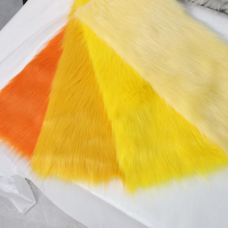 Faux fur fabric with vibrant yellow tones and a 2 inch pile, perfect for creating sunny animal characters, fantasy wigs, or furry plush toys. The synthetic material is soft and plush, yet durable enough for repeated use. Use for fursuit features or costume props where bold color and fluffy texture are needed.