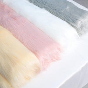 Lightweight faux fox fur with thick 2.36 inch pile, ideal for building fursuit accessories like tails, ears, and paws. The 45 × 85 cm size is perfect for cosplay crafts or plush toy enhancements. The soft synthetic fiber is beginner friendly and machine-sewable, offering the look and feel of real fur in a durable vegan material.