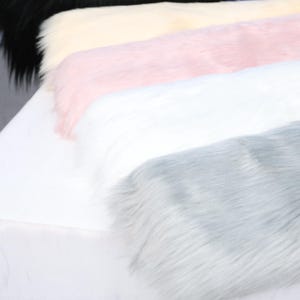 Soft faux fox fur with 6 cm pile height and dense fiber structure. This synthetic fabric offers plush texture and flowing fur ideal for DIY fursuit building. The 17.72 × 33.46 inch cut is great for sewing tails, paws, and ears. Lightweight and durable, this fabric mimics real fur with cruelty-free materials perfect for cosplay or fantasy creature designs.