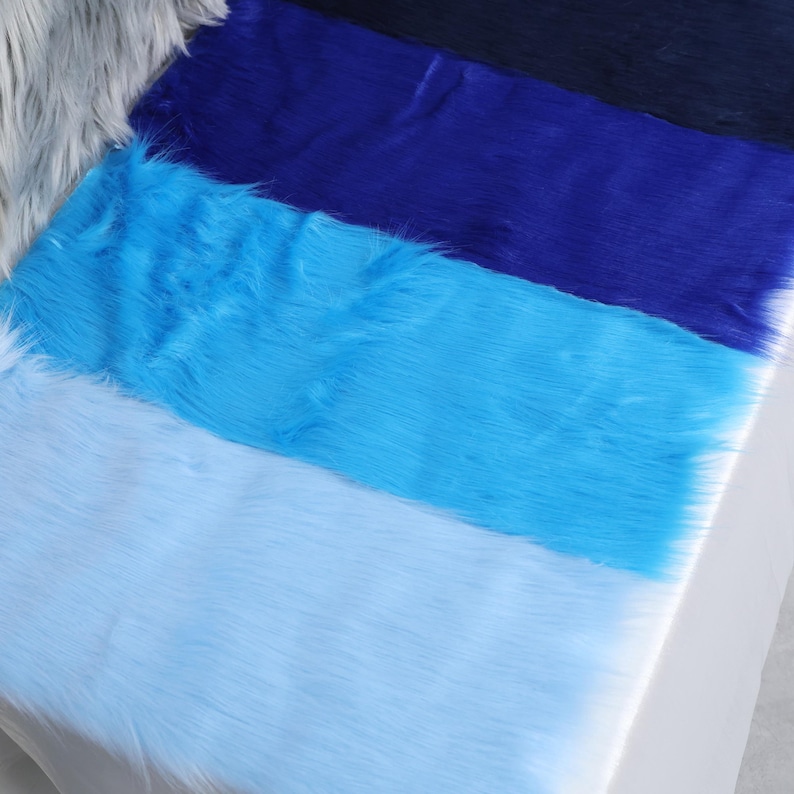 Blue faux fur fabric with 2 inch pile that looks and feels like natural fox fur. Soft, thick, and crafted from synthetic fibers, it's ideal for cosplay costumes, plush accessories, fursuit accents, and more. Use it for animal ears, tails, or fantasy details. The fabric is beginner-friendly, easy to sew, and cut into shape for any small DIY project or costume enhancement.
