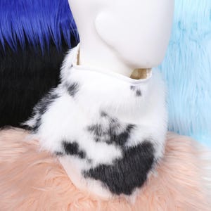Fluffy and cute faux cow fur neck fluff that looks and feels like real fur but is completely vegan. The black and white spotted pattern enhances any animal cosplay or fursuit design. Fully lined interior ensures cozy wear and comfort, ideal for conventions, stage shows, or cold-weather costume events.