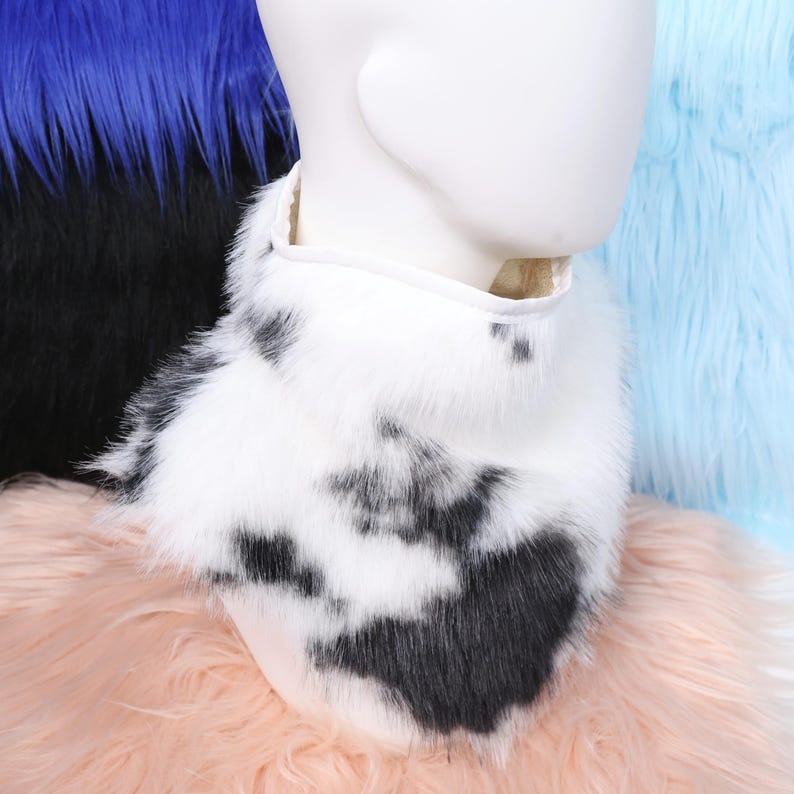 Fluffy and cute faux cow fur neck fluff that looks and feels like real fur but is completely vegan. The black and white spotted pattern enhances any animal cosplay or fursuit design. Fully lined interior ensures cozy wear and comfort, ideal for conventions, stage shows, or cold-weather costume events.
