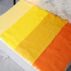 Yellow faux fox fur fabric with a 2 inch pile made from soft synthetic fiber. The bright color and fluffy texture make it ideal for fursuit tails, cosplay accents, plush toys, and costume details. This small 20 × 50 cm cut is perfect for ears, paws, or colorful additions. The fur is easy to sew, cruelty-free, and great for adding bold energy to handmade creations.