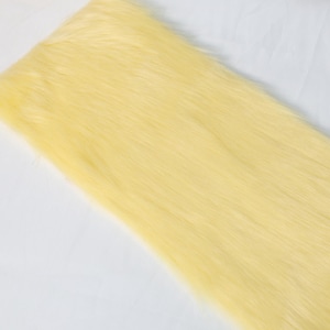 Golden yellow faux fox fur with a 5 cm pile for fursuit detail work and costume crafting. Use it for making ears, tails, paws, or trim. The soft texture and lightweight build make it easy to sew and style. Ideal for small-scale DIY projects, fantasy cosplay, or plush animal designs that need warmth and brightness.