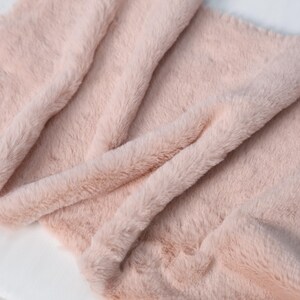 Cozy pink rex-style faux fur fabric with a soft 1–1.5 cm plush pile. Great for sewing soft costume cuffs, plush toy faces, or fursuit features that need gentle, skin-safe texture. Synthetic, cruelty-free, and easy to work with, this fabric is great for both beginners and professionals.