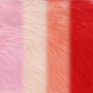 May include: Close-up of a colorful faux fur fabric with vertical stripes. The colors include light pink, cream, peach, and red. The soft, fluffy texture is visible in the image.