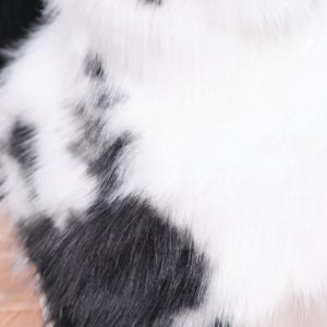 Cow-inspired neck fluff accessory designed with soft faux fur in traditional black and white pattern. Ideal for cosplay, Halloween, and furry events, this piece adds texture and charm to any character outfit. Smooth inner lining enhances comfort, while high-density faux fur fibers mimic natural hair sheen and movement.