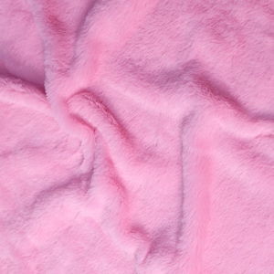 May include: Close-up of a soft, pink faux fur fabric. The plush material has a wavy texture with visible fibers, creating a luxurious and inviting appearance. The color is a vibrant, solid pink, suitable for various craft and design projects.