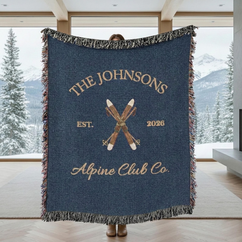 Personalized alpine blanket displayed as woven cotton throw in a ski chalet style mountain cabin living room navy