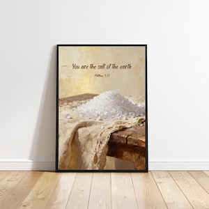 May include: Framed art print featuring a pile of coarse salt on a wooden table, draped with a tan cloth. The text "You are the salt of the earth" and "Matthew 5:13" are printed at the top.