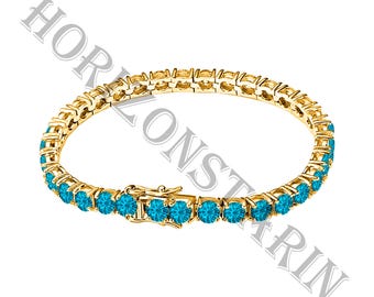 May include: A gold-tone tennis bracelet featuring a continuous row of round, bright blue gemstones set in metal prongs. The bracelet includes a secure box clasp mechanism. The text HORIZONSTARIN is overlaid across the image in a large, semi-transparent font.