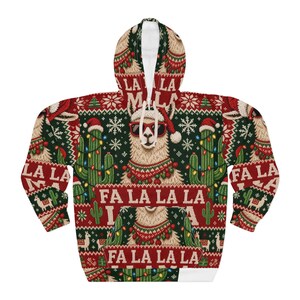 May include: A red and dark green hooded sweatshirt featuring a repeating pattern of llamas wearing Santa hats and sunglasses, decorated cacti with string lights, snowflakes, and the repeated text FA LA LA LA LA across the front.