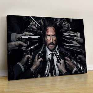May include: A canvas print depicting a man in a suit and tie, surrounded by hands holding guns. The image has a dark, dramatic aesthetic, with a focus on the central figure and the weapons. The man has a serious expression.