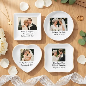 May include: Four white ceramic trinket dishes with gold rims, each featuring a photograph and text. The shapes include a square, a circle, a heart, and a scalloped square. The text includes dates and phrases like "Mother of the Groom" and "Thank you, Mom."