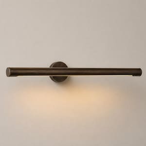 May include: A horizontal wall-mounted light fixture with a dark bronze finish. The cylindrical bar features a central circular mounting plate and emits a warm, soft glow from the underside, illuminating the space directly below the fixture.