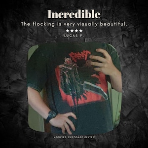 May include: Black t-shirt with a red and black graphic design. The shirt features the word "Incredible" at the top, along with a customer review. The shirt is a short-sleeved crew neck.