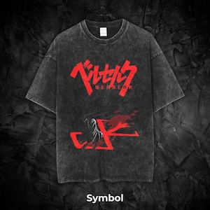 May include: Dark gray t-shirt with a distressed look. The front features red Japanese text and the word "BERSERK" in red. Below the text is a red graphic with a white skeletal design. The word "Symbol" is printed at the bottom.