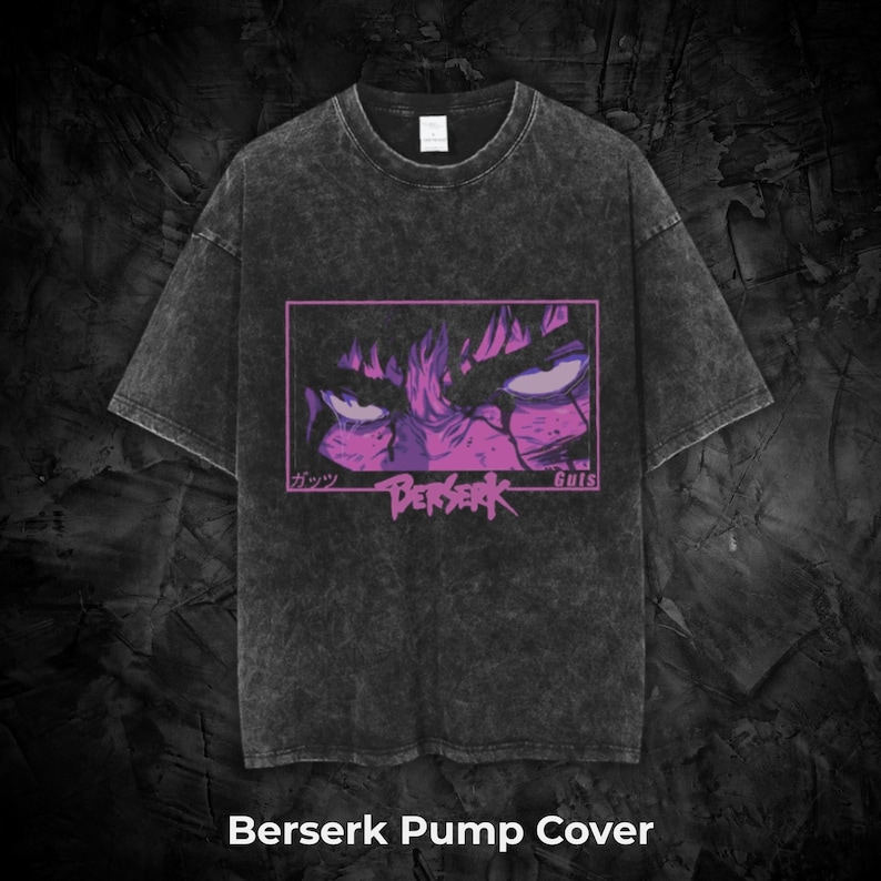 May include: Dark gray t-shirt with a graphic of a character's eyes and face in a purple and pink rectangular frame. The word "Berserk" is printed below the graphic. The text "Berserk Pump Cover" is printed at the bottom of the shirt.