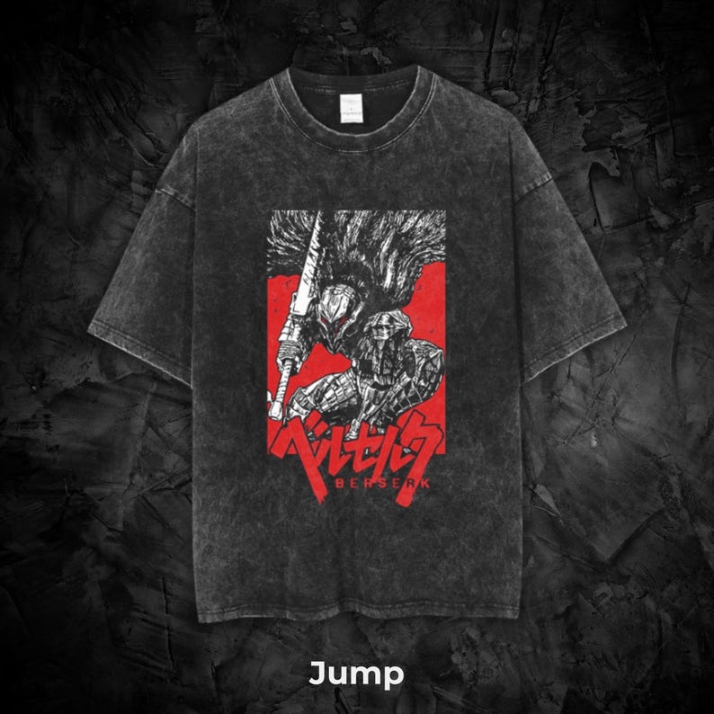 May include: Dark gray t-shirt featuring a red rectangle with a black and white illustration of a warrior holding a large sword. The word "BERSERK" is printed in red below the illustration. The word "Jump" is printed at the bottom.