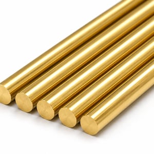 May include: Five polished brass rods arranged in a parallel row. Each rod features a smooth, cylindrical shape with a reflective, metallic gold-toned surface and flat, circular ends. The rods are positioned diagonally across the frame.