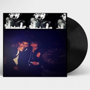 May include: A black vinyl record with a cover featuring a black and white image of three wolf heads and people. The record is a music album.