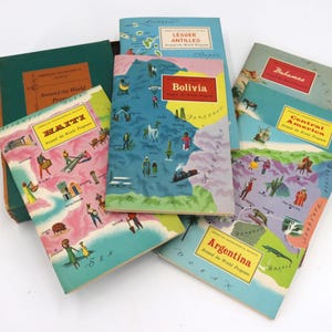 May include: A collection of vintage "Around the World Program" books. The covers feature colorful illustrations of various countries, including Bolivia, Haiti, and Argentina. The books have a retro aesthetic with a mix of blues, pinks, and greens.