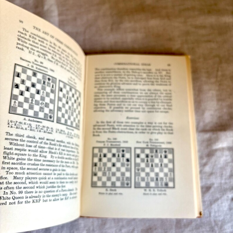 May include: Open book with text and chess diagrams. The pages are yellowed with age. The text discusses chess strategy and tactics, with diagrams illustrating various game positions and moves. The book is open to page 95.