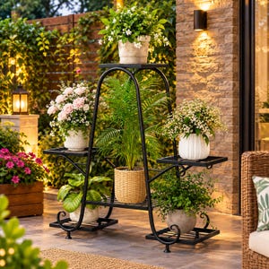 May include: A black metal plant stand with an arched frame and multiple tiers, holding six potted plants of various sizes and types, including a central palm, flowering shrubs, and greenery in textured, woven, and ribbed ceramic containers.