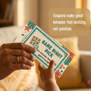 May include: A person holding a "Game Night Pick" coupon card with a dice and board game graphic. The card has a teal border with floral and starfish accents. The text "Coupons make good behavior feel exciting, not punitive" is also visible.