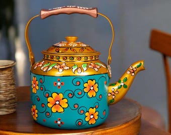 May include: A teal and gold hand-painted teapot with a floral design. The teapot features orange and yellow flowers, a copper-colored handle, and a gold spout. The lid and rim are also gold, creating a vibrant and decorative piece.