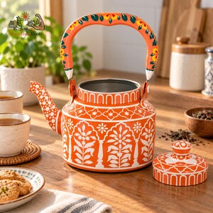 May include: An orange metal teapot featuring a white floral pattern and a matching lid. The handle is painted with orange, yellow, and green floral motifs. The spout is orange with white polka dots. The teapot has a wide base and a silver interior.