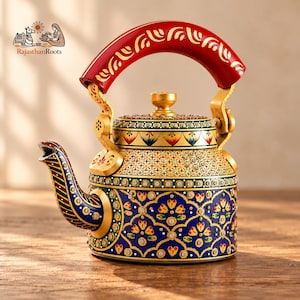 May include: A decorative metal teapot featuring a vibrant red handle with gold patterns, a gold lid, and a blue body adorned with intricate floral motifs, geometric designs, and small embedded crystals. The spout is striped in red, green, and blue.