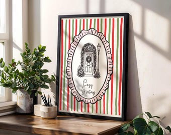 May include: A framed print with a black border features a festive design. The artwork showcases a detailed illustration of a door adorned with a wreath, a lamppost, and the words "Cozy Greetings." The background has vertical stripes in red, green, and white.