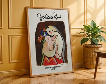 Może przedstawiać: Oprawiony wydruk artystyczny zatytułowany "Mother and Child with Poppy 1937-38" przedstawia kolorową ilustrację matki i dziecka. Grafika jest w jasnej drewnianej ramie i opiera się o żółtą ścianę. W pobliżu stoi roślina doniczkowa.