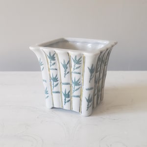 May include: A set of three ceramic mugs with a speckled, matte finish. The mugs are in shades of cream, light gray, and dark gray. Each mug has a simple, minimalist design, perfect for coffee or tea.