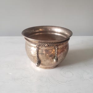 May include: A set of three ceramic mugs with a speckled, matte finish. The mugs are in shades of cream, light gray, and dark gray. Each mug has a simple, minimalist design, perfect for coffee or tea.